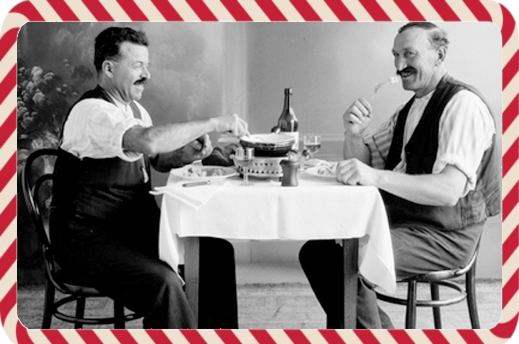 Fondue à l'ancienne partagée par deux amis avec un bon verre de vin blanc.